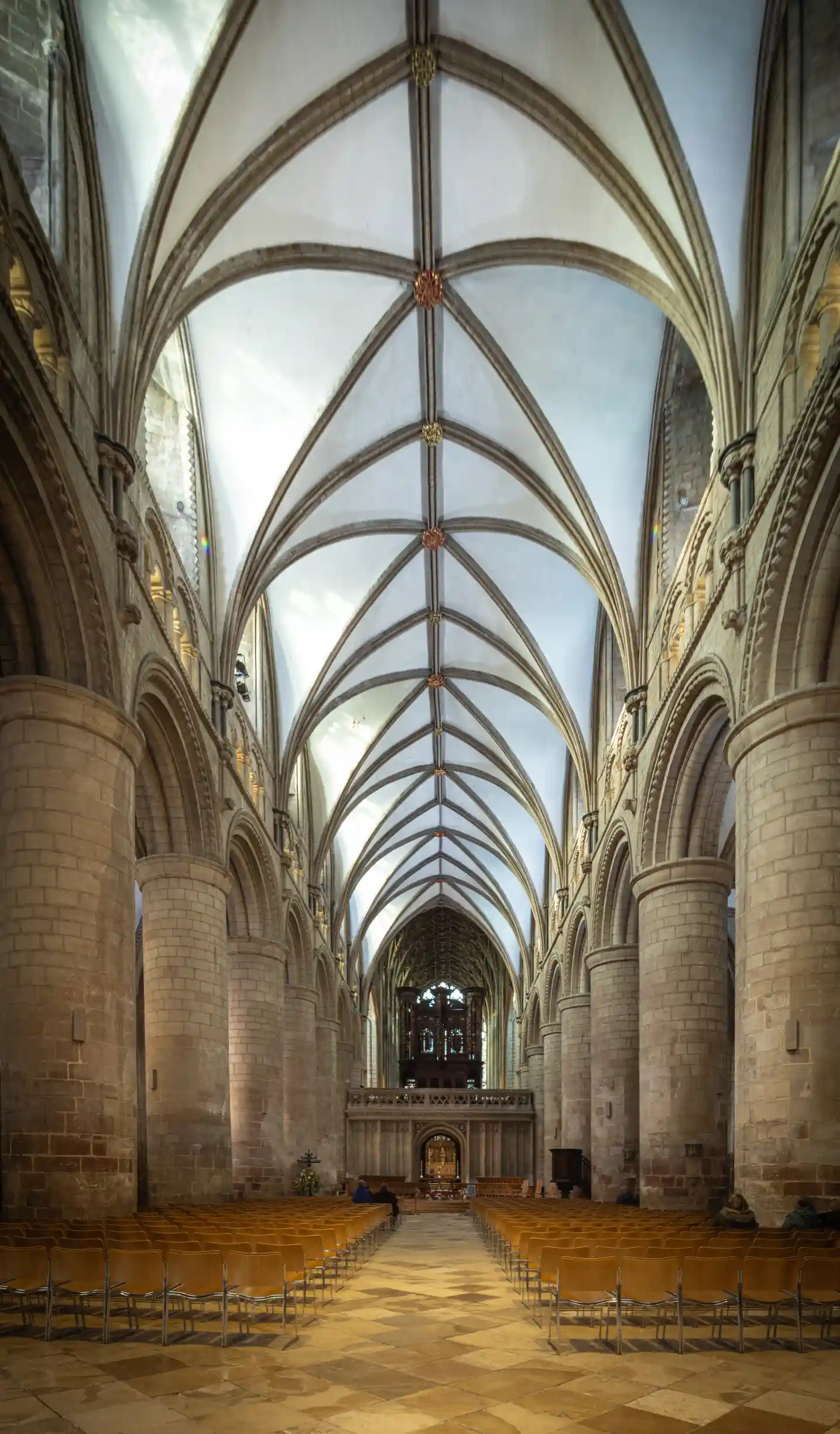 Modern architecture with glass rooftop overlooking the sky.