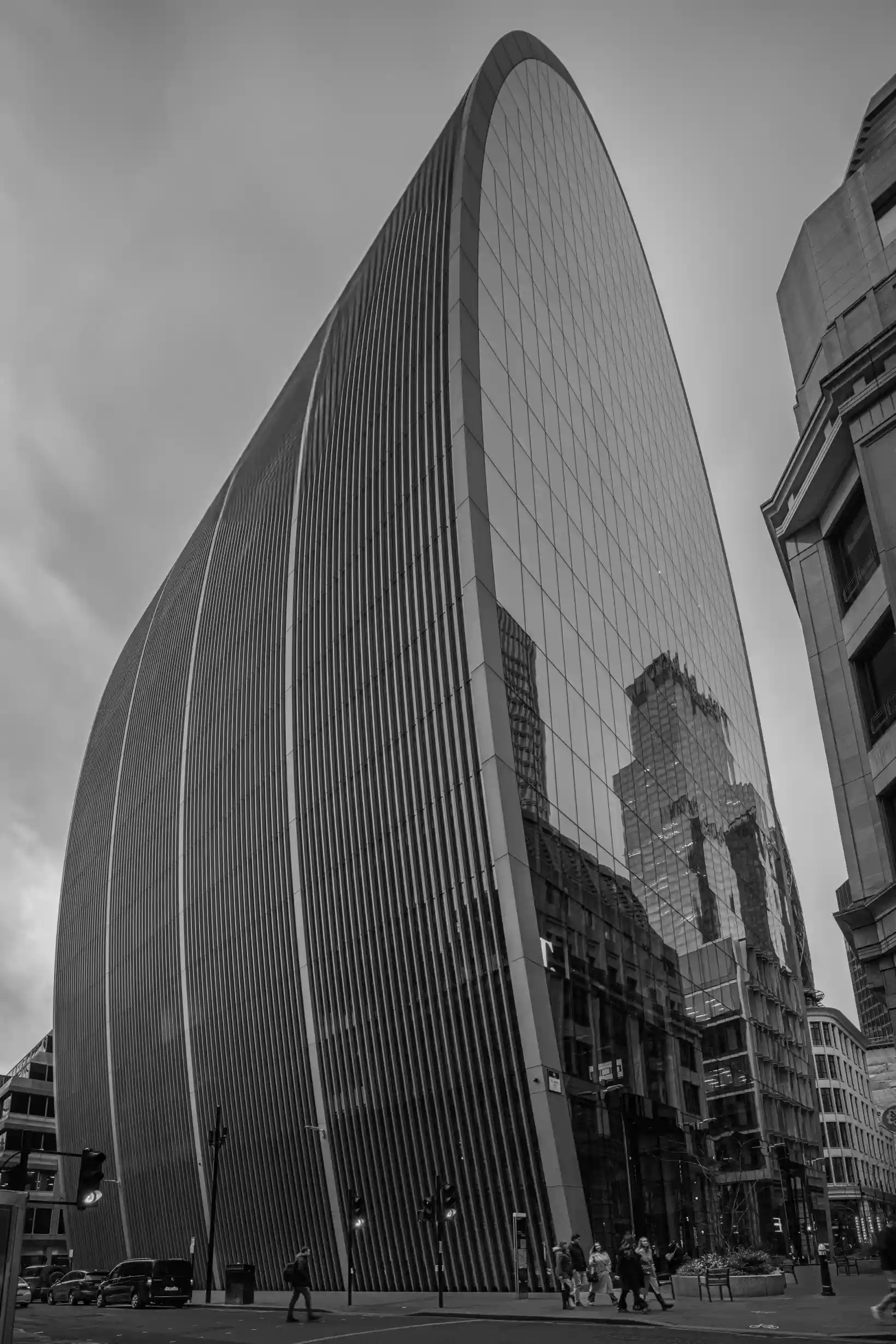 Modern architecture with glass walls reflecting the surrounding city.