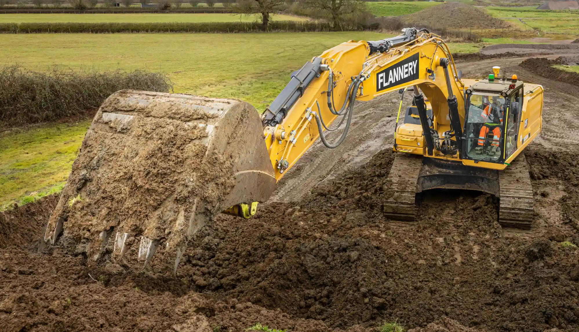 Heavy excavator machine working on railway construction site.