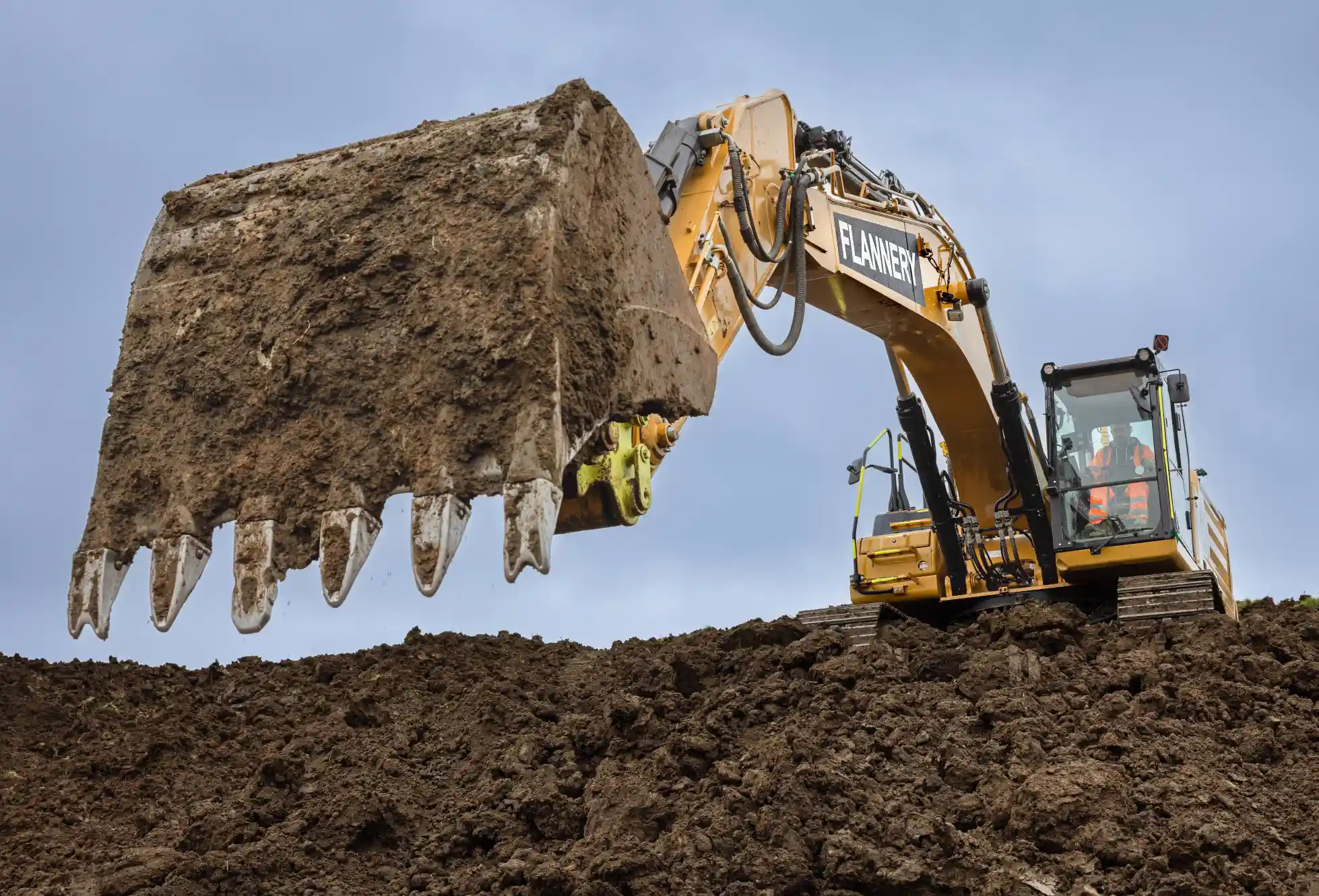 Heavy excavator operating on a stockpile.